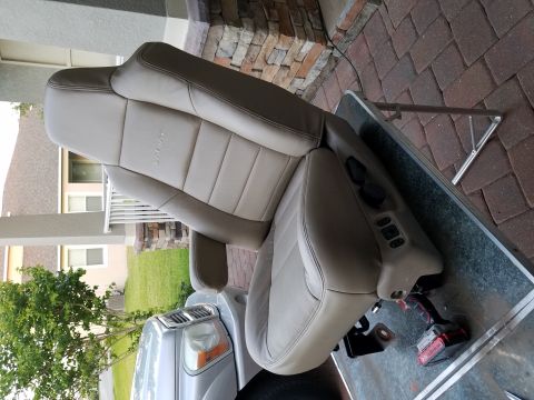 1994 Ford Bronco - Car seat with power controls is removed and placed on a table.