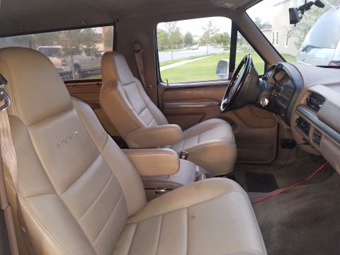 1994 Ford Bronco - Interior view of a 1994 Ford Bronco, highlighting the front tan leather seats and dashboard.