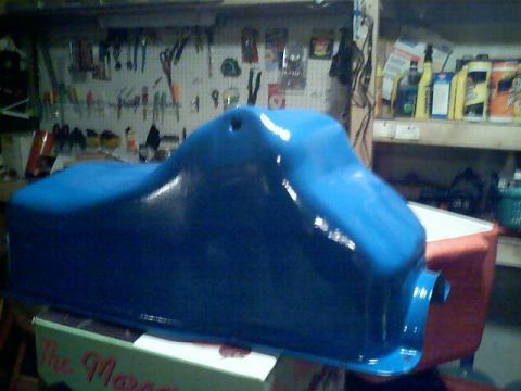 1989 Ford Bronco - A freshly painted blue oil pan sits on a box in a workshop.