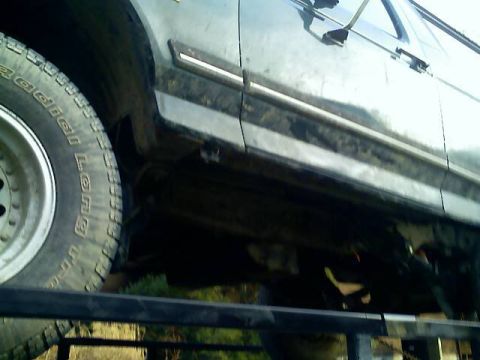 1989 Ford Bronco - Side view of a 1989 Ford Bronco, its door, trim, and a BFGoodrich tire.