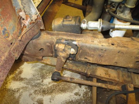 1967 Ford F-250 - Close-up of rusty steering linkage and leaf spring assembly, likely from an older truck.