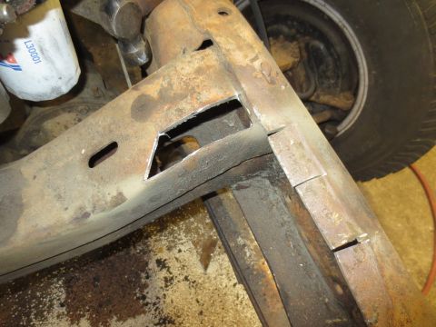 1967 Ford F-250 - Close-up of a heavily rusted truck frame, showing a cut-out section and an oil filter.