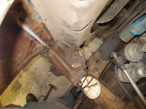 1967 Ford F-250 - Close-up view of the steering and suspension system of a 1967 Ford F-250, showing significant rust on the frame components.
