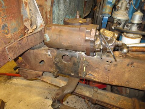 1967 Ford F-250 - Close-up of a rusty steering gear box assembly attached to the vehicle's frame.