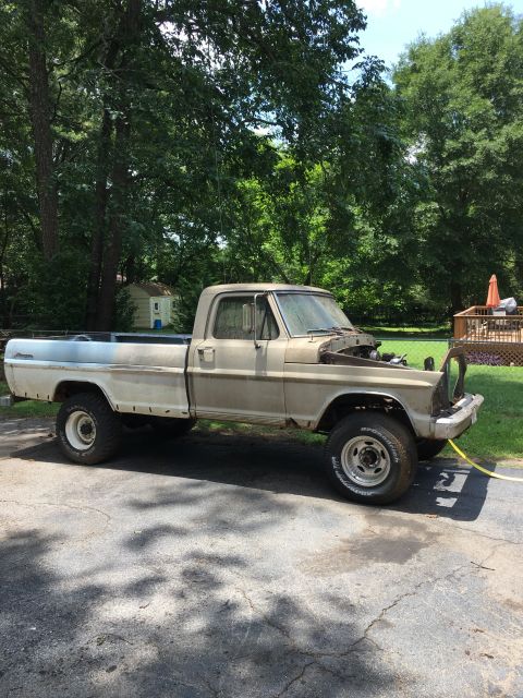 1967 Ford F-250 - This 1967 Ford F-250 pickup truck is parked outside with its hood up.