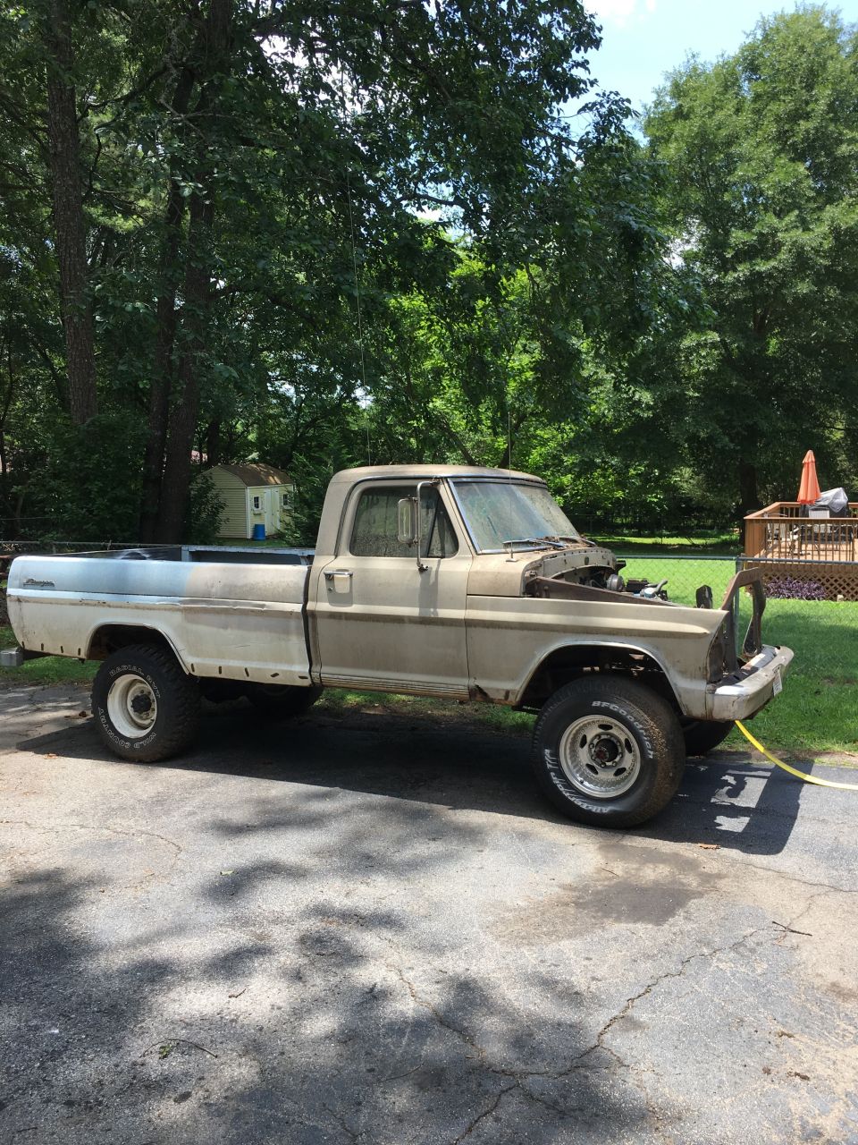 1967 Ford F-250 pickup truck with hood open, parked in a driveway