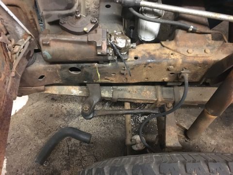 1967 Ford F-250 - Underneath view of truck steering and suspension parts, showing rust and wear.