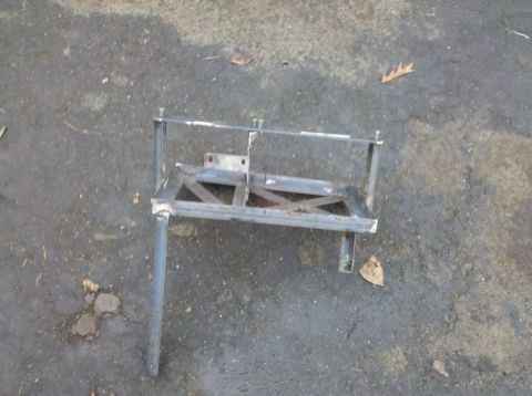 1989 Ford Bronco - A custom metal bracket is shown resting on an asphalt surface.