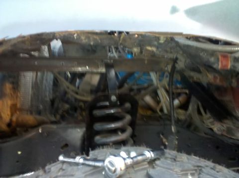 1989 Ford Bronco - Close-up view of the engine bay, highlighting suspension components and a tangle of wires. The Supermotors.net watermark is present.