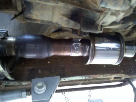 1989 Ford Bronco - Underside view of a vehicle's exhaust system, showing a muffler and pipe connections.