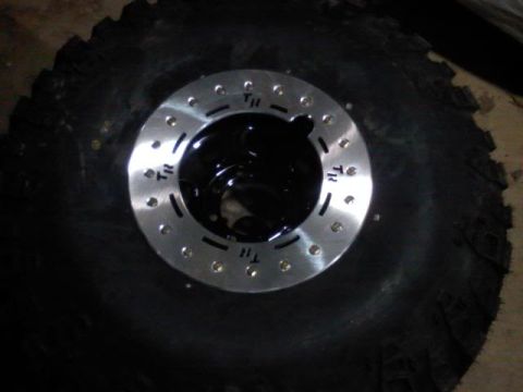 1989 Ford Bronco - A close-up view of a tire and wheel assembly, with visible markings on the wheel.