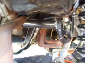1989 Ford Bronco - Close-up view of the undercarriage, highlighting mechanical parts and suspension system.