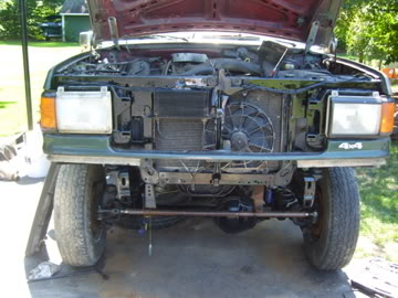 1989 Ford Bronco - Front view of a green 1987 Ford Bronco with its hood open, revealing the engine compartment and radiator assembly.