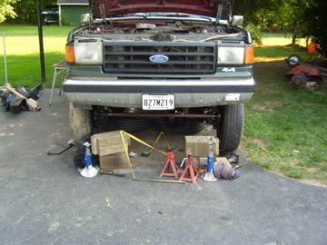1989 Ford Bronco - Front view of a 1989 Ford Bronco undergoing maintenance, showing the grille and headlights.
