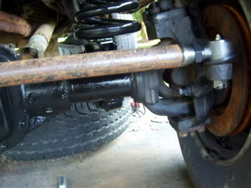 1989 Ford Bronco - This photo shows a close-up view of a vehicle's suspension and steering components, including the tie rod end and brake assembly.