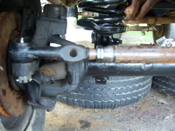 1989 Ford Bronco - A detailed view of the front suspension system and tire of an unidentified vehicle.