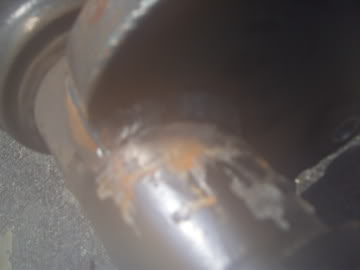 1989 Ford Bronco - A close-up view of a rusty exhaust pipe, showing signs of wear and tear.