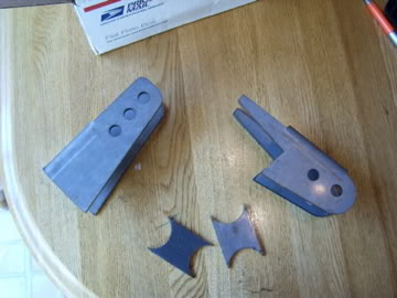 1989 Ford Bronco - Metal brackets and small metal pieces are shown on a wooden table.