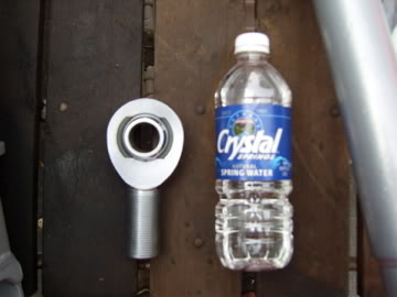 1989 Ford Bronco - A rod end bearing is shown next to a bottle of Crystal Spring Water for scale.
