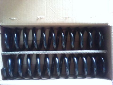 1989 Ford Bronco - Two sets of black coil springs are visible inside a cardboard box.