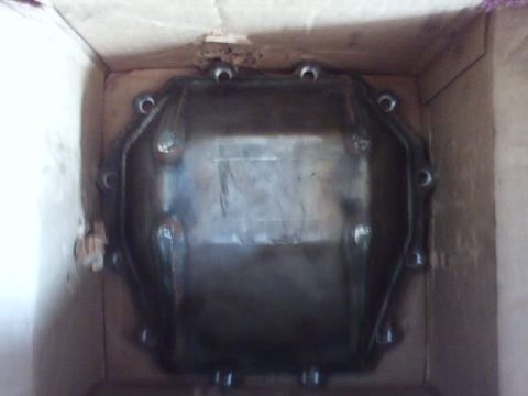 1989 Ford Bronco - A dark metal differential cover is shown inside a cardboard box.