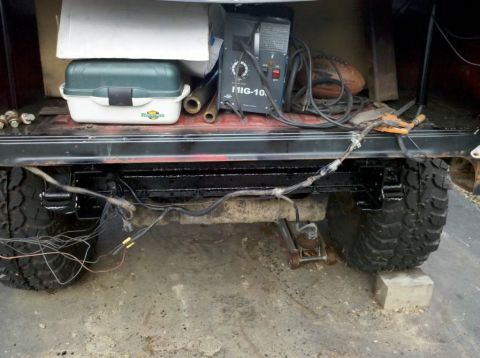 1989 Ford Bronco - Welding machine and fishing tackle box stored in the rear of a vehicle.