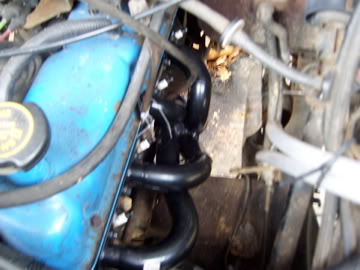 1989 Ford Bronco - Close-up view of an engine compartment, showing the valve cover and exhaust system.