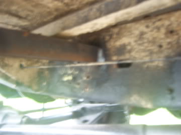 1989 Ford Bronco - Underside view of a vehicle's frame and suspension components, showing signs of wear and age.