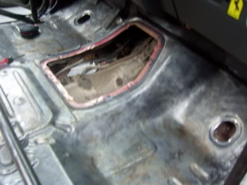 1989 Ford Bronco - Interior view of a vehicle's floor pan, showing exposed metal and a cut-out section.