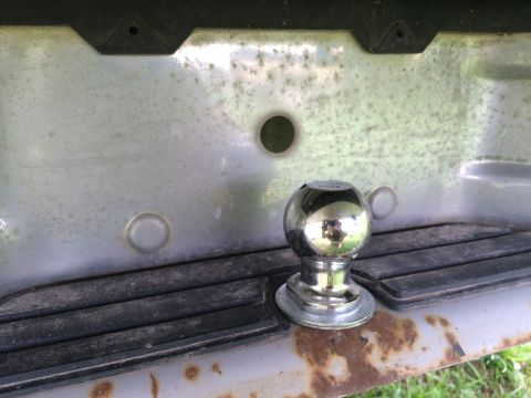 1993 Ford Bronco - Close-up of a trailer hitch ball mounted on a vehicle's rear bumper.
