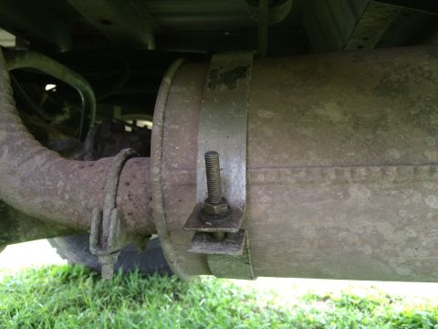 1993 Ford Bronco - Detail of a vehicle's exhaust system, showing a muffler and pipe connection.