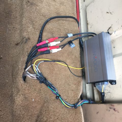1985 Ford F-350 - Car stereo amplifier and wiring installed on the carpeted floor of a vehicle.
