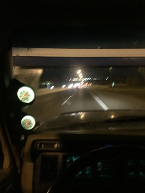 1985 Ford F-350 - Driving on a highway at night, with illuminated gauges visible on the dashboard.