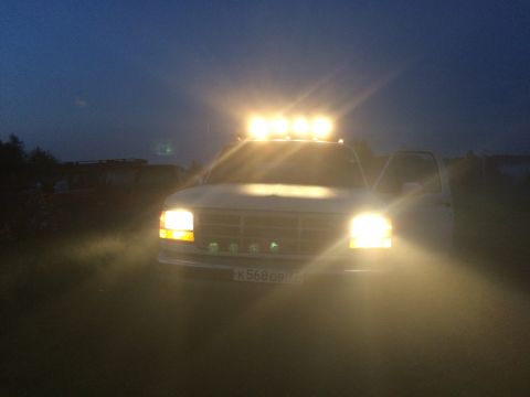 1993 Ford Bronco - Front view of a white 1993 Ford Bronco equipped with auxiliary lighting on the roof and bumper.