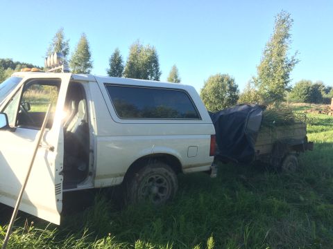 1993 Ford Bronco - This 1993 Ford Bronco is parked in a grassy field with its door open, hitched to a trailer.