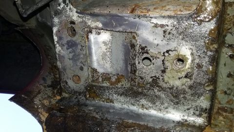 2000 Pontiac Grand Prix - Underside view of heavily corroded vehicle frame structure with visible mounting points.