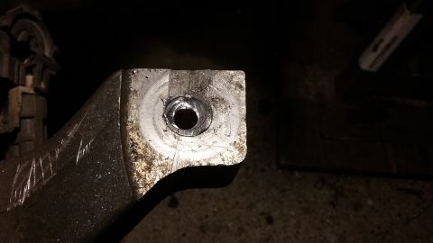 2000 Pontiac Grand Prix - A close-up view of a metal bracket with a hole in it.