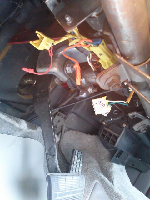 1998 Chevrolet C/K Pickup - Wiring and pedals visible under the dashboard of a vehicle.