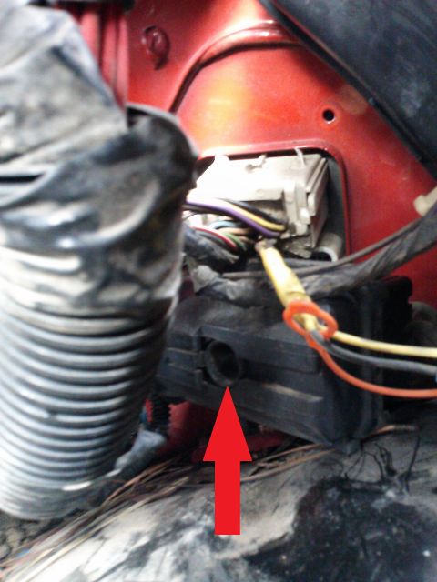 1998 Chevrolet C/K Pickup - Close-up of interior wiring harness and fuse box, with a red arrow indicating a specific connector.