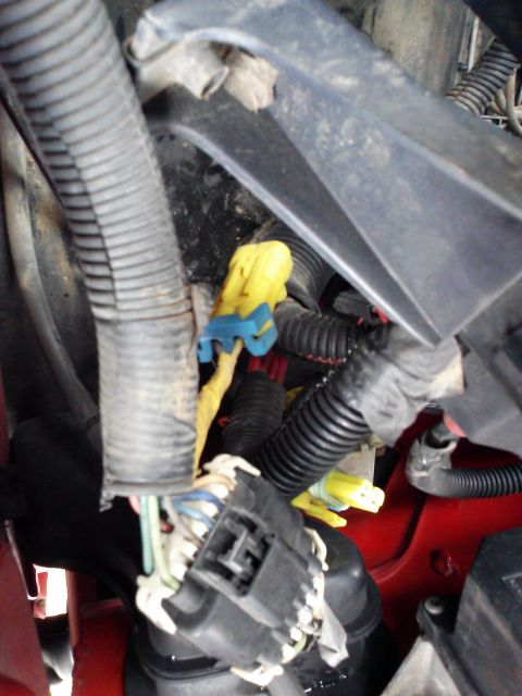1998 Chevrolet C/K Pickup - Engine bay wiring harness with multiple connectors, including yellow and blue ones.