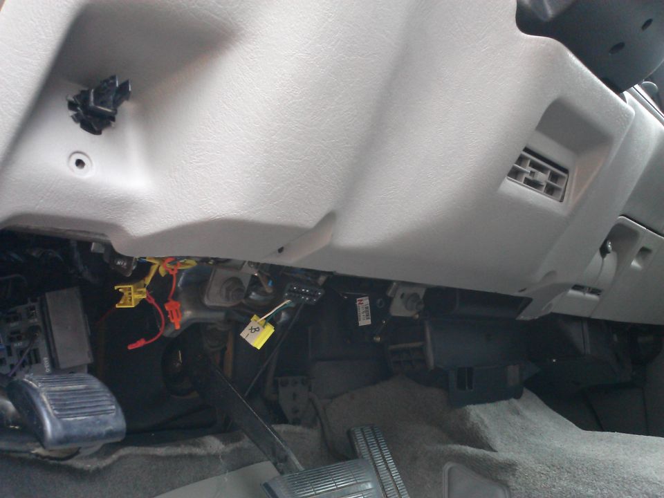 1998 Chevrolet C/K Pickup interior showing dashboard, pedals, and exposed wiring under the dash