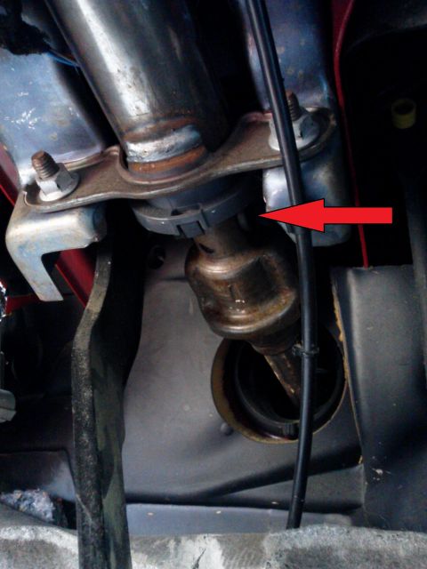 1998 Chevrolet C/K Pickup - A red arrow highlights a plastic clip on the steering column linkage assembly in this vehicle interior shot.