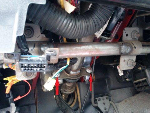 1998 Chevrolet C/K Pickup - Close-up view of the steering column bracket and wiring harness in a 1998 Chevrolet C/K Pickup.