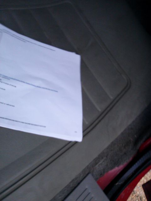 1998 Chevrolet C/K Pickup - A document rests on the floor mat inside a vehicle's interior, with a Supermotors.net watermark.