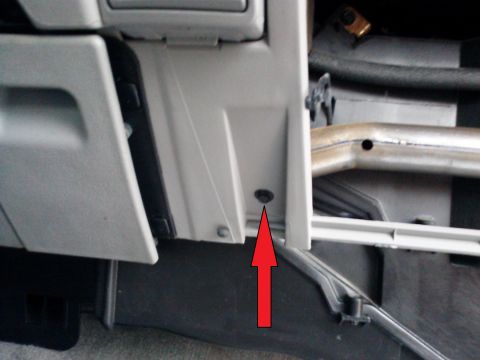 1998 Chevrolet C/K Pickup - Close-up view of an interior vehicle component, with a red arrow highlighting a screw.