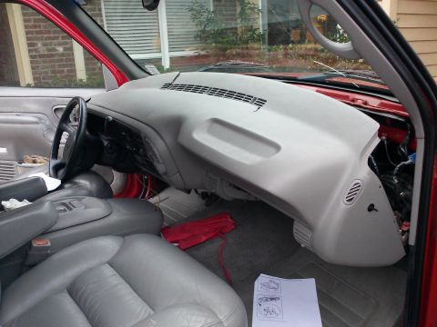 1998 Chevrolet C/K Pickup - Interior view of a red truck with the dashboard partially disassembled, revealing wiring and components.