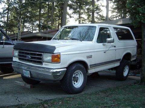 1988 Ford Bronco - This 1987 Ford Bronco is parked in a driveway with trees in the background.