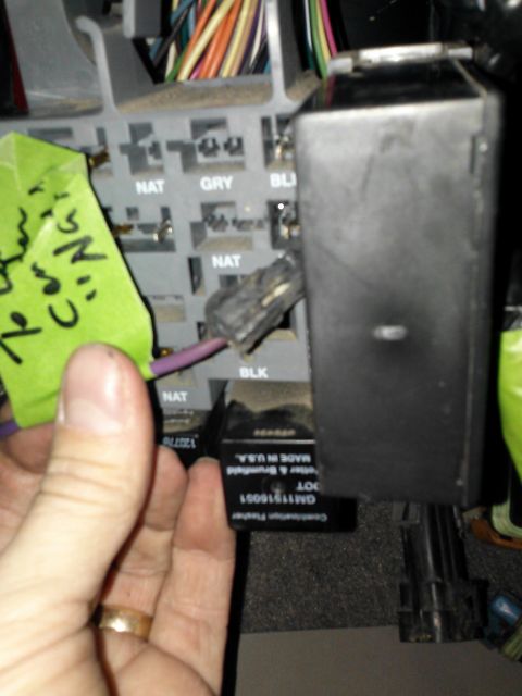 1998 Chevrolet C/K Pickup - Close-up of a vehicle's interior fuse box, showing wiring and relays.
