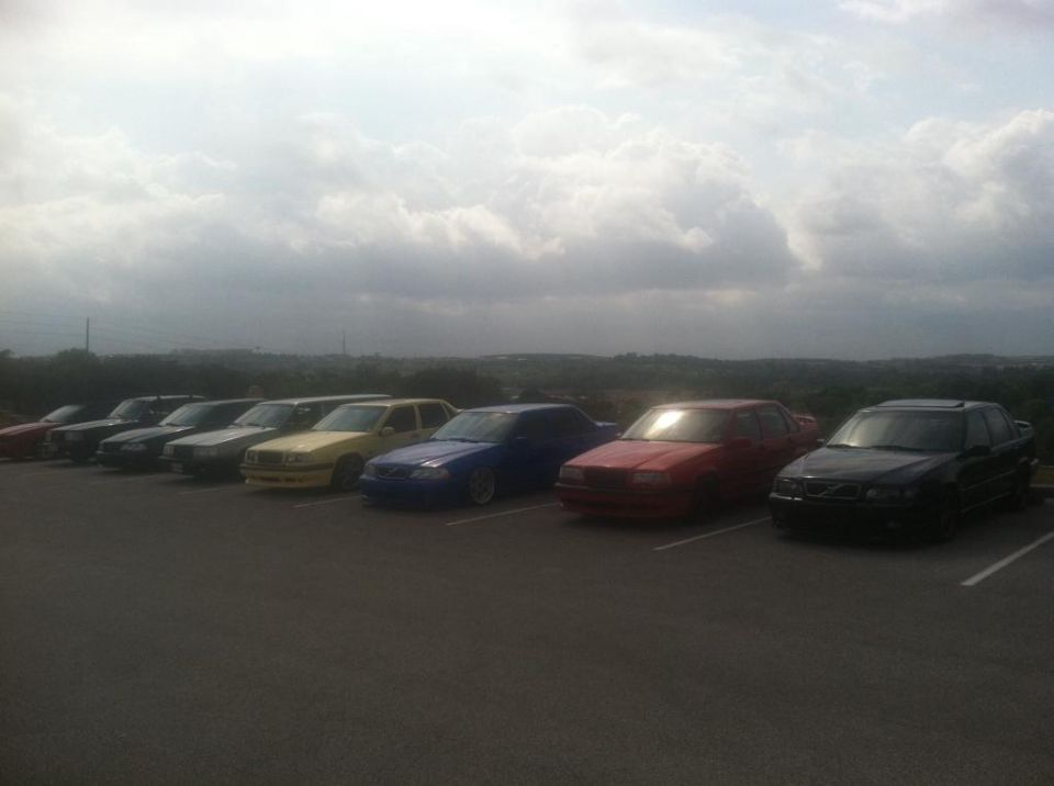 Several sedans parked in a row.