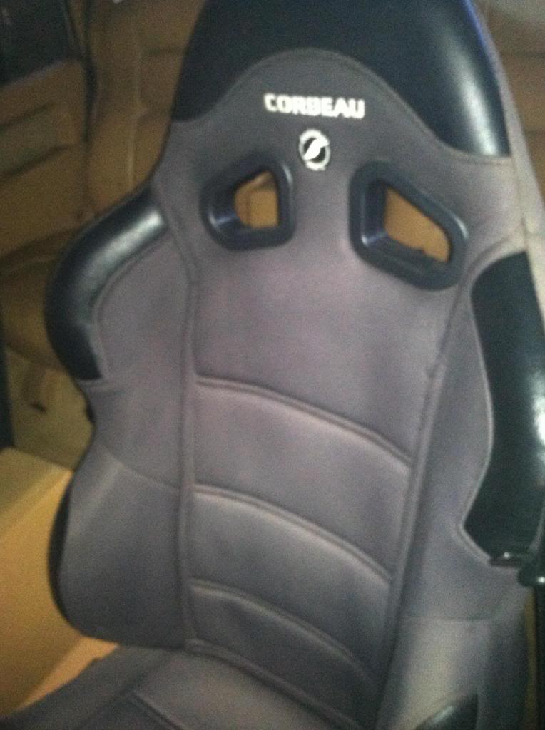 Corbeau racing seat with grey fabric and black leather accents.